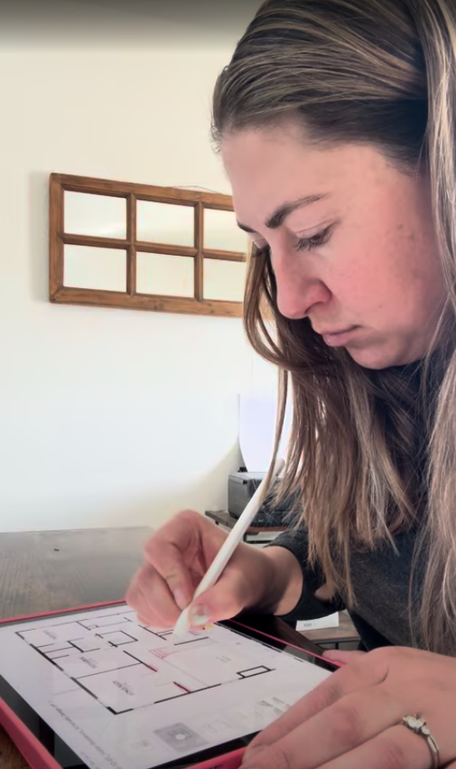 Colorado licensed architect Heather Hanson reviewing a home floor plan
